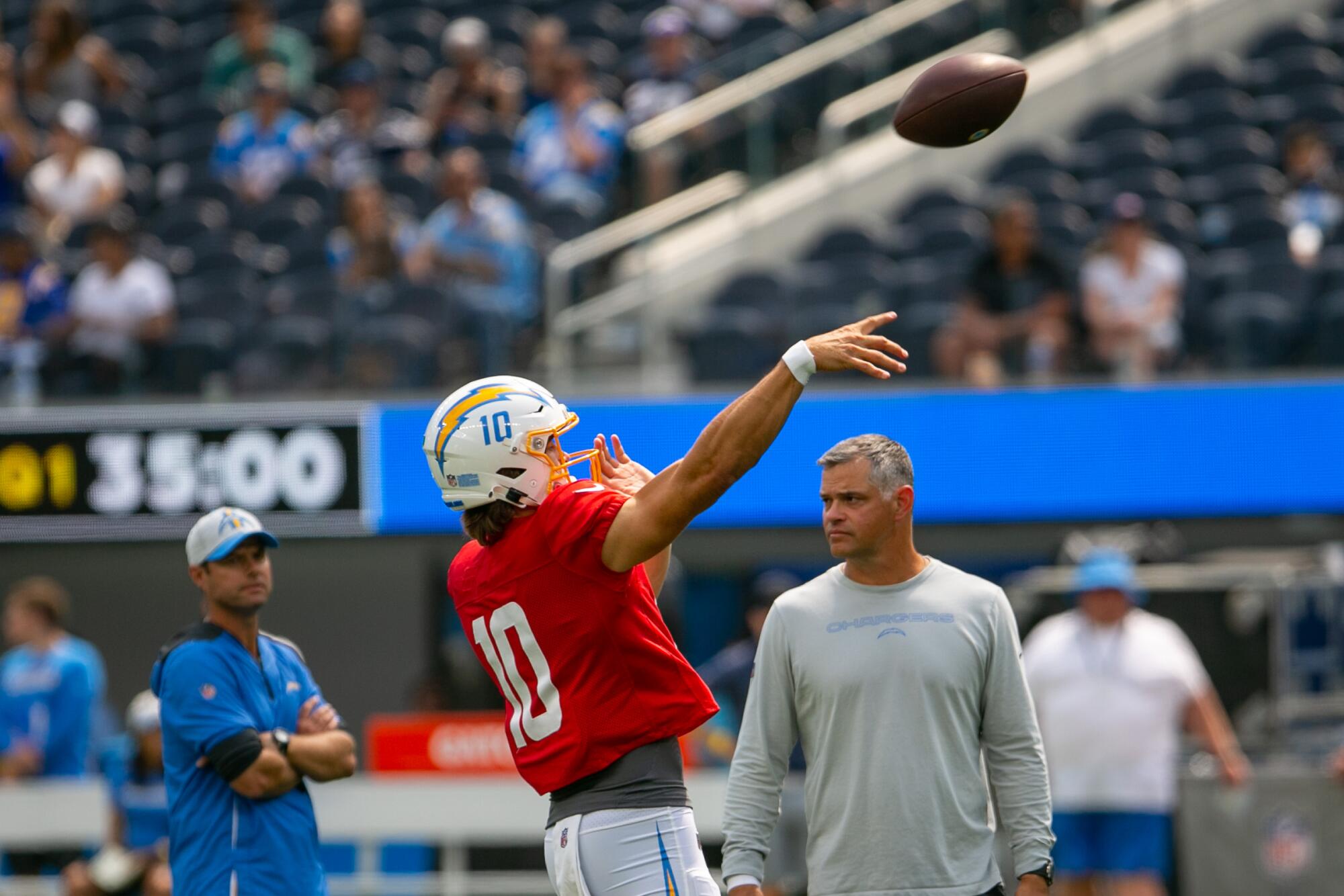Chargers quarterback Justin Herbert throws a pass at SoFi Stadium during the Fan Fest and open practice on Sunday.
