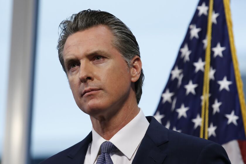 Gov. Gavin Newsom listens to a reporters question concerning his announcement that California schools will likely remain closed for the rest of the school year, but provide off-site education due to the coronavirus, during a news conference at the Governor's Office of Emergency Services in Rancho Cordova, Calif. in Rancho Cordova, Calif., Wednesday, April 1, 2020. The state is not mandating that schools remain closed through the summer break but offering guidance and recommendations on distance learning for schools. (AP Photo/Rich Pedroncelli, POOL)