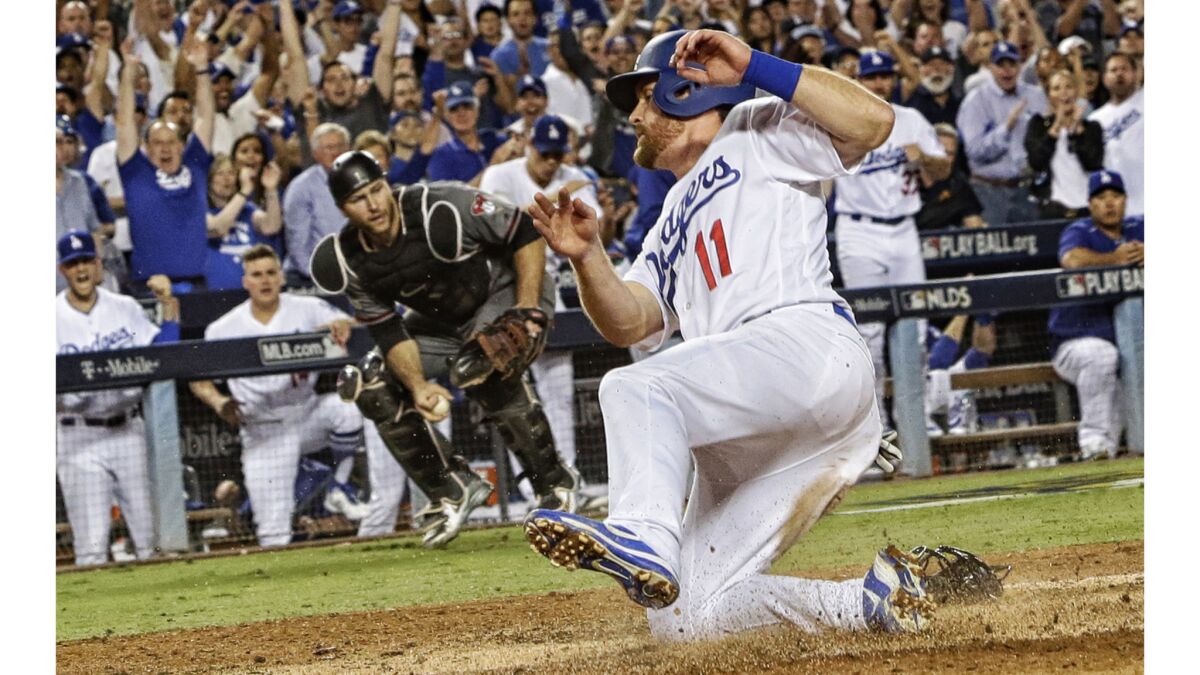 Dodgers second baseman Logan Forsythe scores on a wild pitch by DBacks pitcher Robbie Ray.