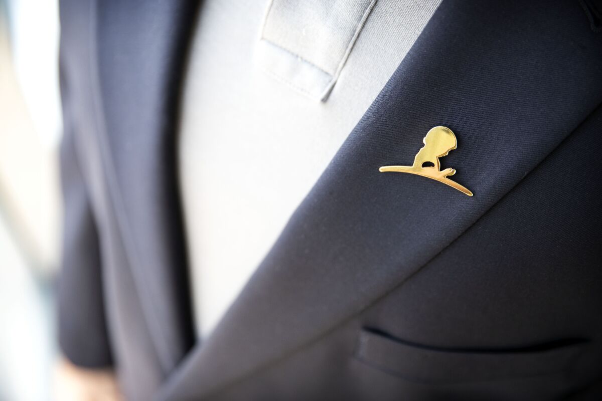 A St. Jude Children's Research Hospital lapel pin on a jacket.