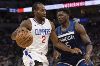 Los Angeles Clippers forward Kawhi Leonard (2) works towards the basket while Minnesota Timberwolves guard Anthony Edwards (5) defends during the first half of an NBA basketball game, Sunday, Jan. 14, 2024, in Minneapolis, Minn. (AP Photo/Bailey Hillesheim)