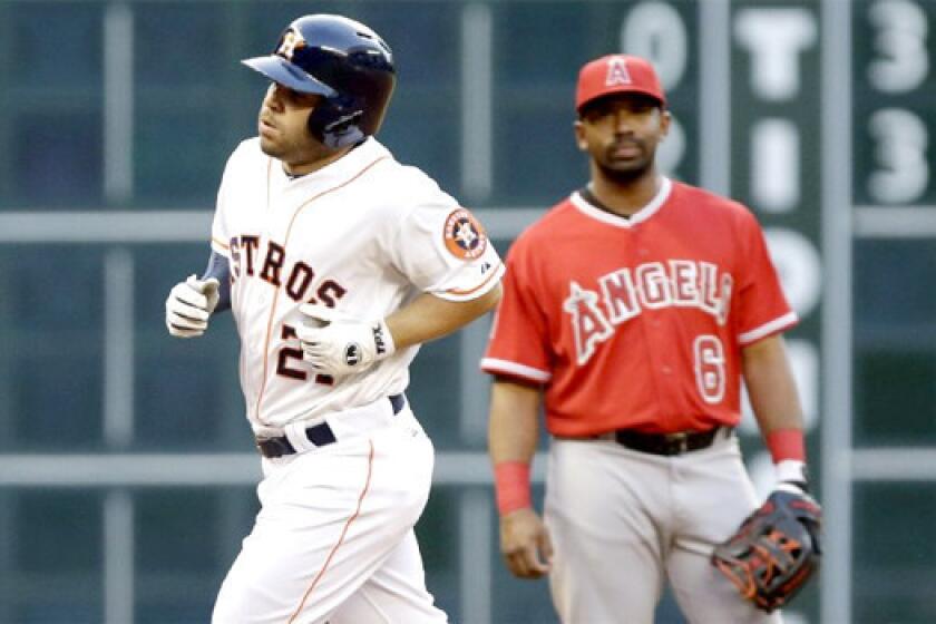 Jose Altuve rounds the bases after hitting a home run in his first at-bat against the Angels in the Astros' 7-6 victory Tuesday.