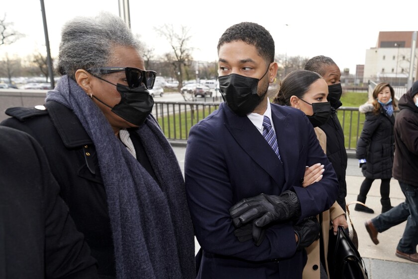Actor Jussie Smollett looks back at his mother as they arrive with other family members Monday, Nov. 29, 2021, at the Leighton Criminal Courthouse for jury selection at his trial in Chicago. Smollett is accused of lying to police when he reported he was the victim of a racist, anti-gay attack in downtown Chicago nearly three years ago, in Chicago. (AP Photo/Charles Rex Arbogast)