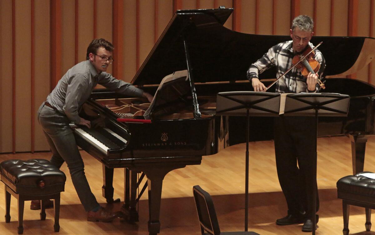 Richard Valitutto, left, and violinist Mark Menzies throw their all into "Igeltsoen Laborategia."