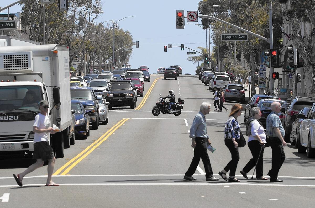 Pedestrians cross South Coast Highway in Laguna Beach. Conflicts between motorists and pedestrians are among problems cited in a study of Pacific Coast Highway between Seal Beach and San Clemente.