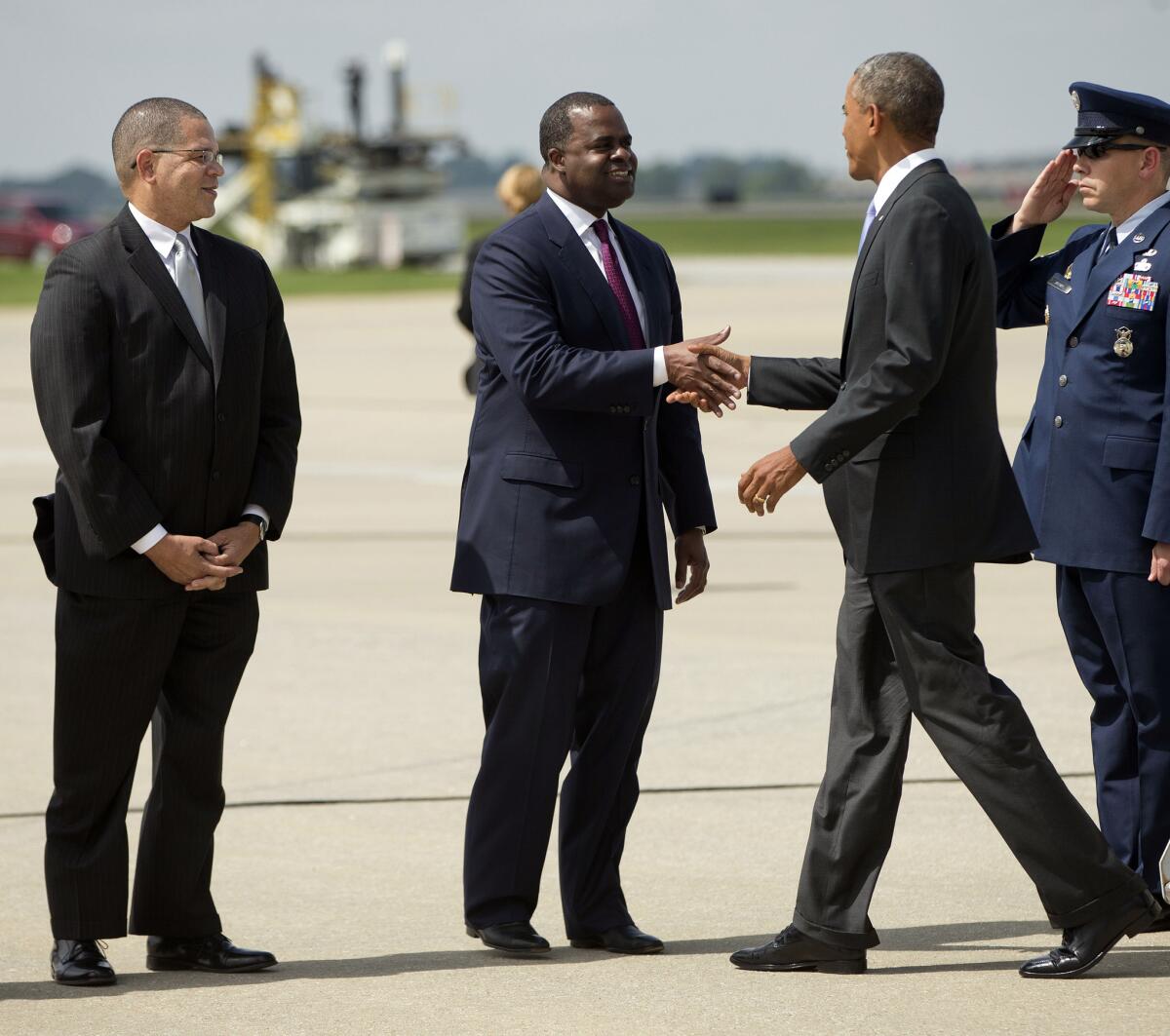 President Obama, right, is greeted by Atlanta Mayor Kasim Reed, center, and Fulton County Commissioner John Eaves, left, upon his arrival in Atlanta on Sept. 16.