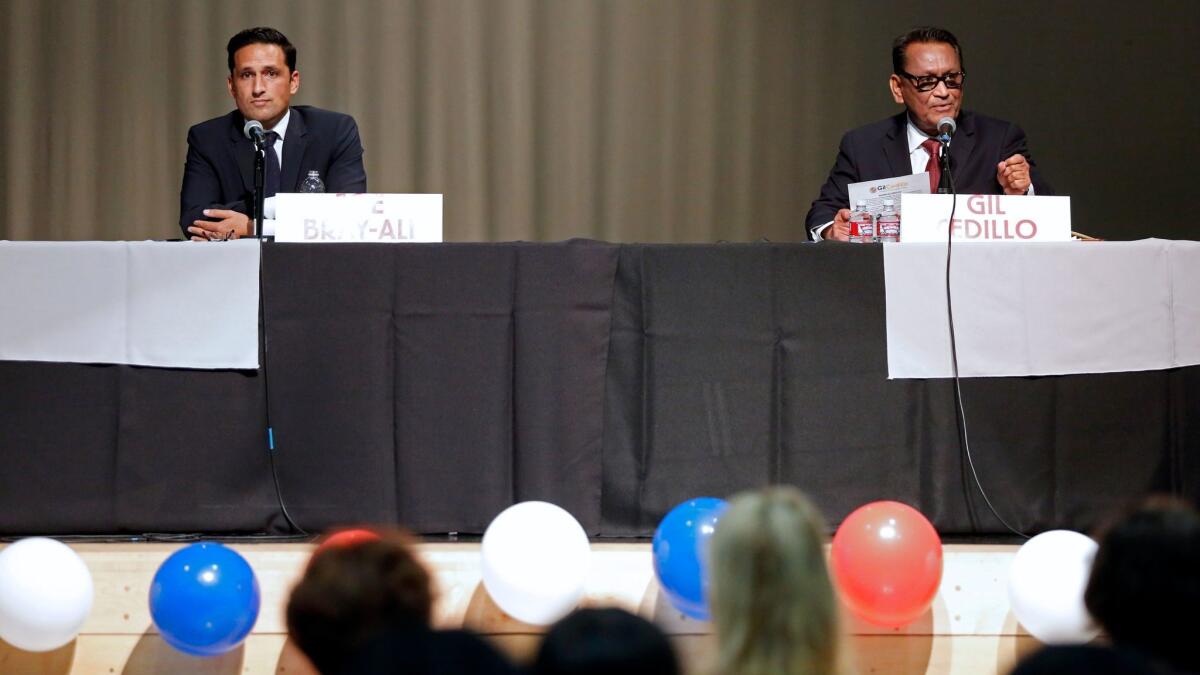 Joe Bray-Ali, left, and Councilman Gil Cedillo at a candidates forum for Council District 1 last month.