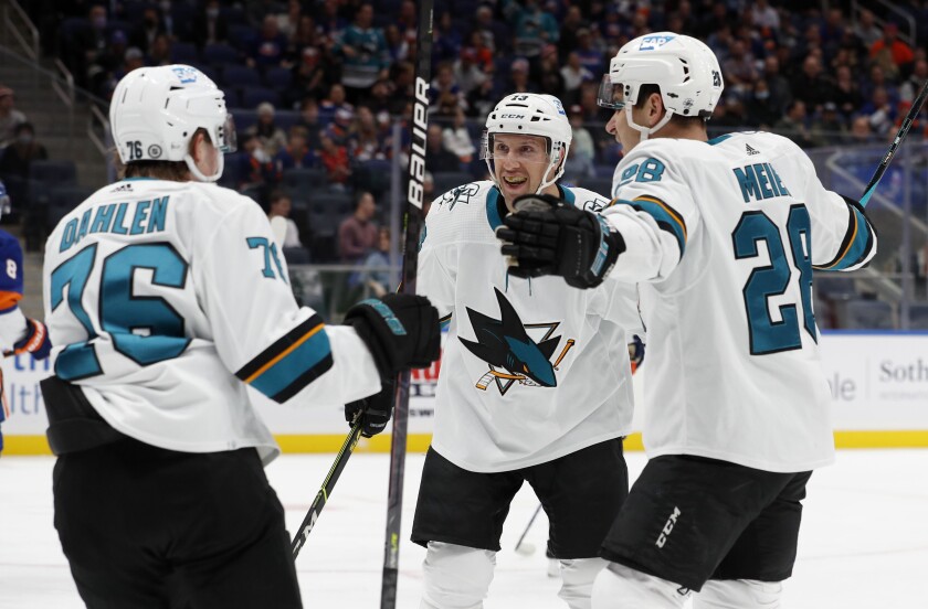 San Jose Sharks center Nick Bonino (13) celebrates his goal against the New York Islanders with teammates Jonathan Dahlen (76) and Timo Meier (28) during the first period of an NHL hockey game on Thursday, Dec. 2, 2021, in Elmont, N.Y. (AP Photo/Jim McIsaac)