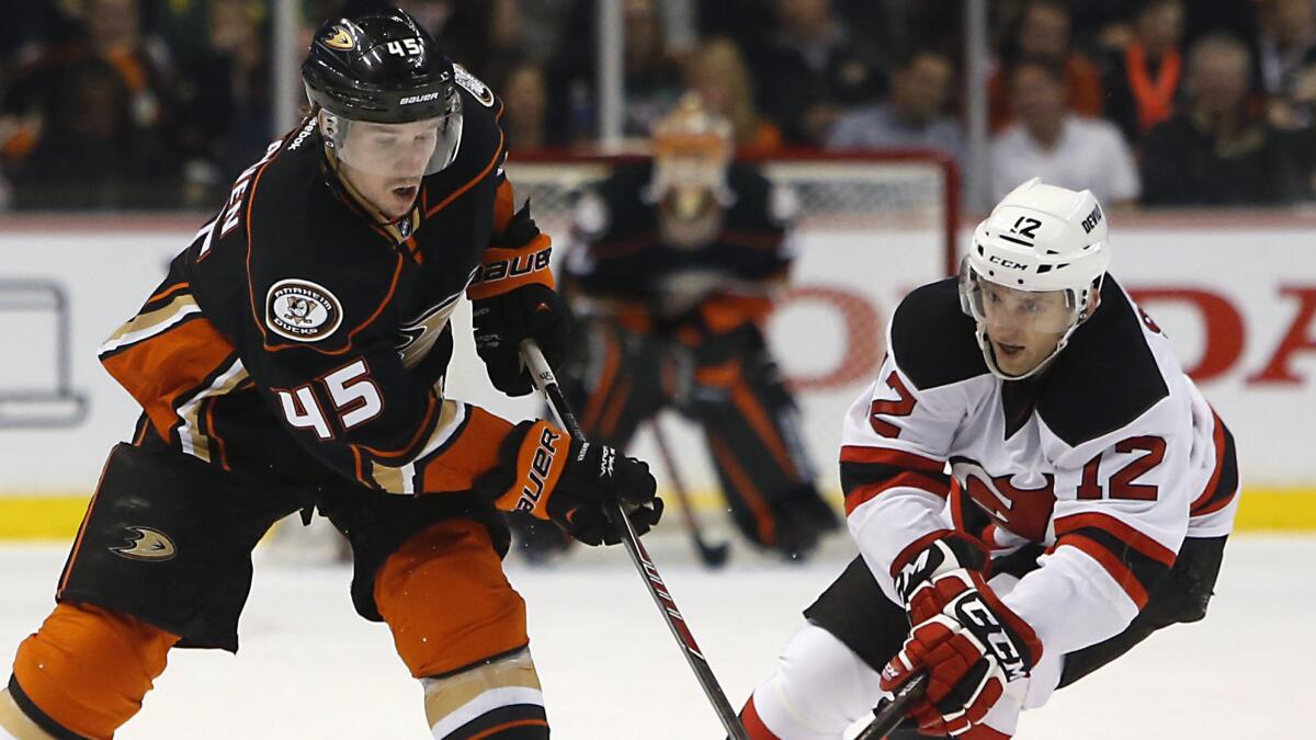 Ducks defenseman Sami Vatanen, left, passes in front of New Jersey Devils forward Tom Sestito during the second period of the Ducks' 5-1 win at Honda Center on Friday.