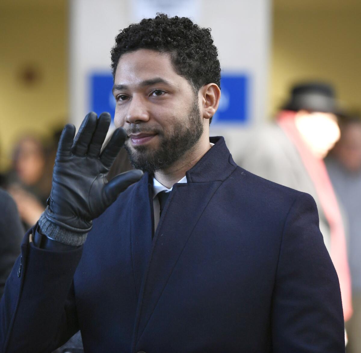 Jussie Smollett waves to supporters before leaving Cook County Court after his charges were dropped Tuesday.