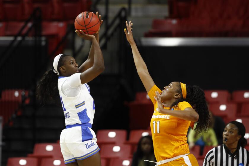 UCLA forward Michaela Onyenwere, left, shoots over Tennessee center Kasiyahna Kushkituah in the second half of a first-round game in the NCAA women's college basketball tournament, Saturday, March 23, 2019, in College Park, Md. Onyenwere contributed a game-high 22 points im UCLA's 89-77 win. (AP Photo/Patrick Semansky)