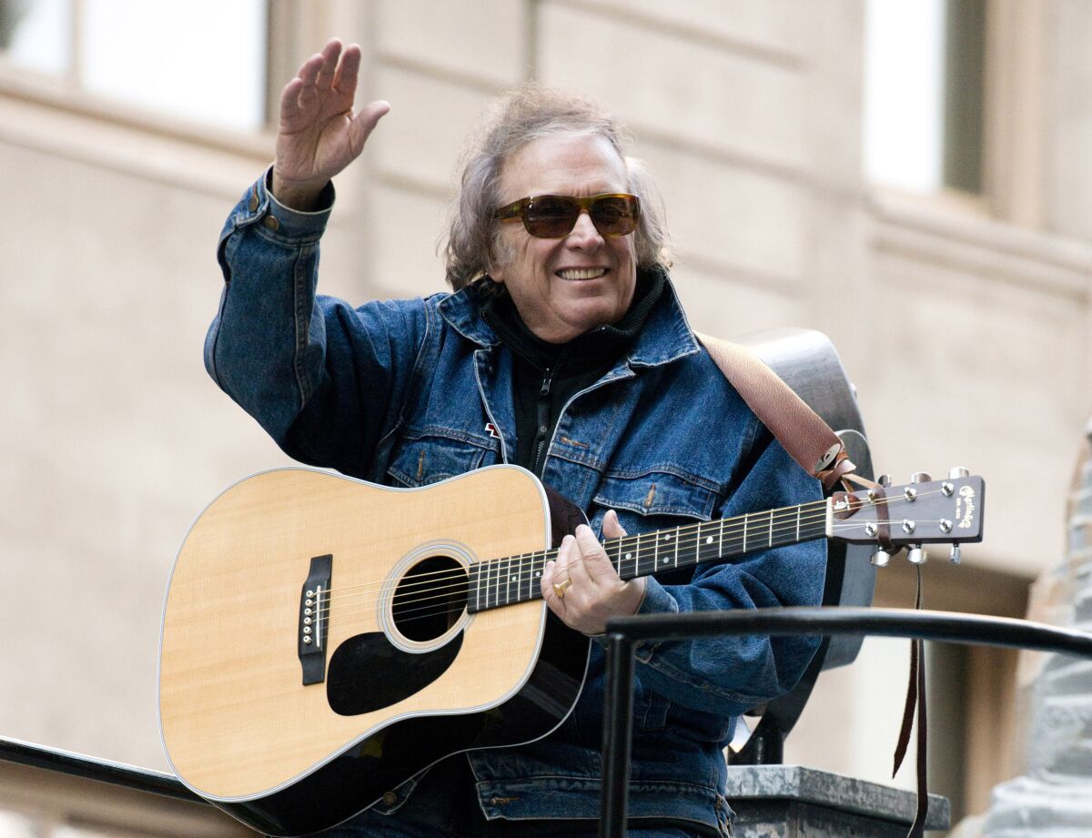 FILE - Don McLean rides a float in the Macy's Thanksgiving Day Parade in New York. Feb. 22, 2019. For all those fans of the iconic song "American Pie" who have sometimes wondered about the lyrics they are singing loudly, singer-songwriter Don McLean shares the secrets in the new full-length feature documentary, "The Day the Music Died: The Story of Don McLean's 'American Pie.'". (AP Photo/Charles Sykes, File)