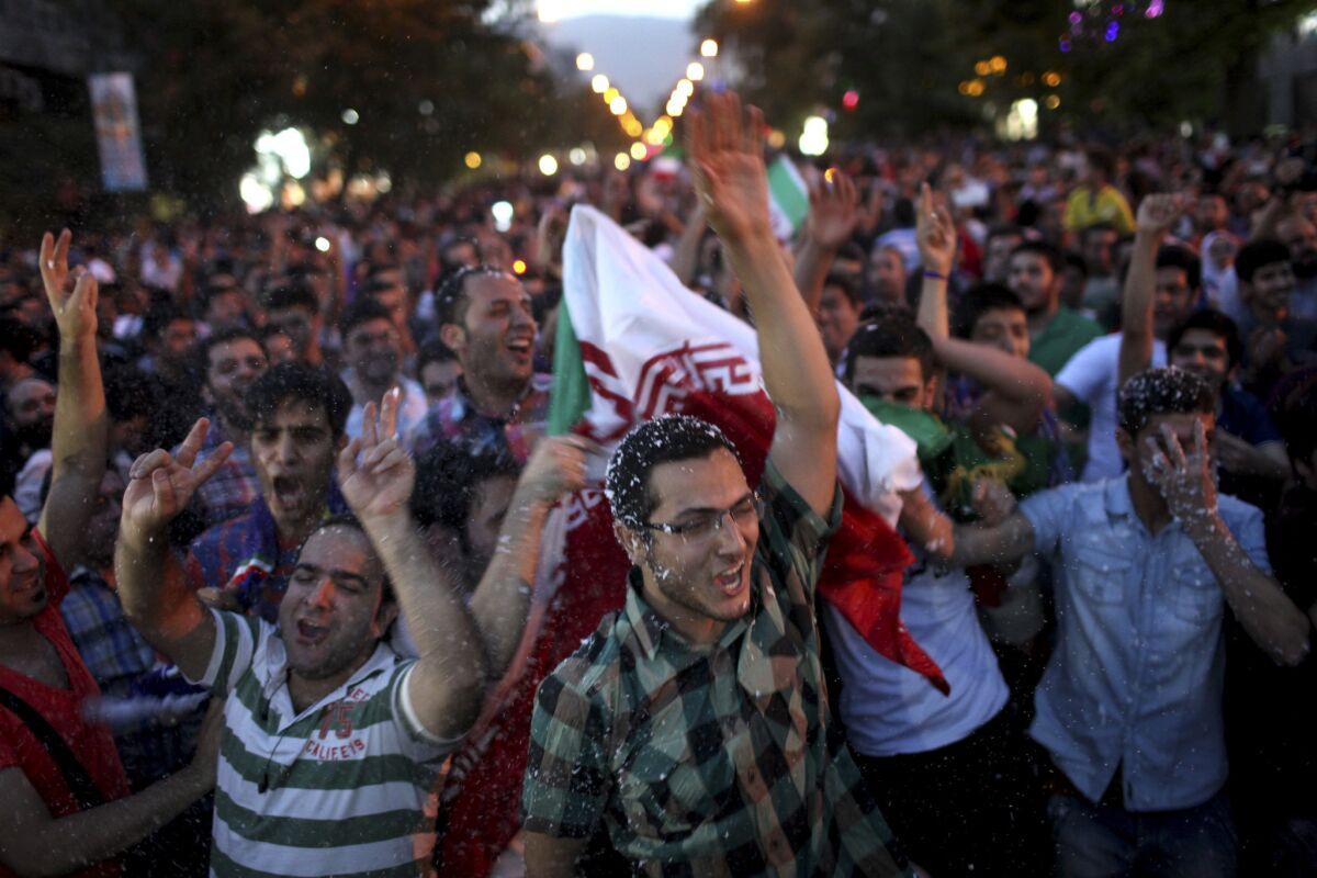 Iranians celebrate in the capital, Tehran, after their national soccer team qualified for the 2014 World Cup.