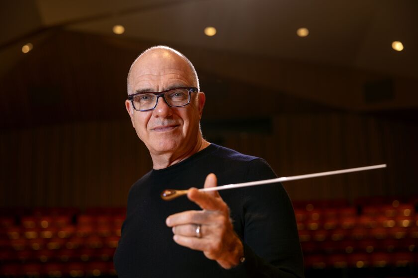 SAN DIEGO, CA - APRIL 28, 2022: Steven Schick, who is stepping down as Music Director of the La Jolla Symphony and Chorus, balances his conducting baton on his finger while in the the Conrad Prebys Music Center's concert hall at UCSD in San Diego on Thursday, April 28, 2022. (Hayne Palmour IV / For The San Diego Union-Tribune)
