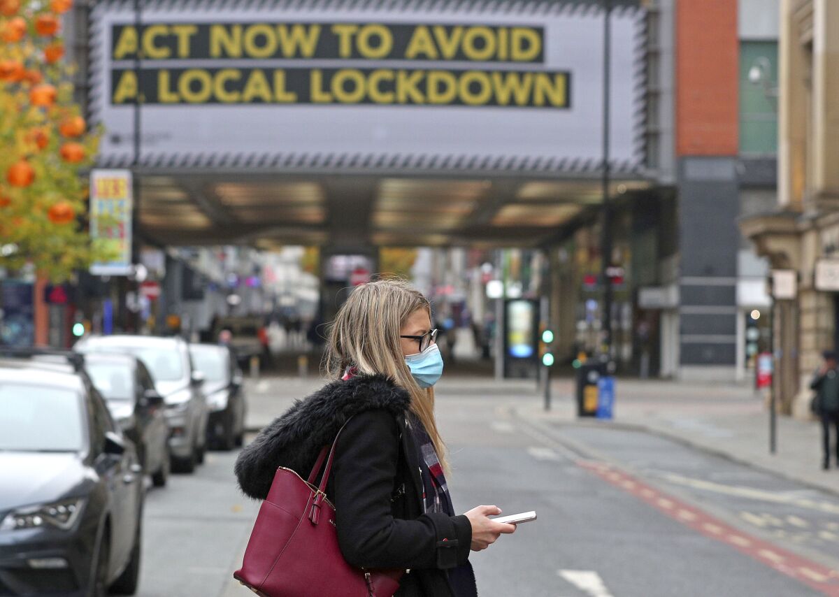 A woman wearing a face mask in Manchester, England, on Monday