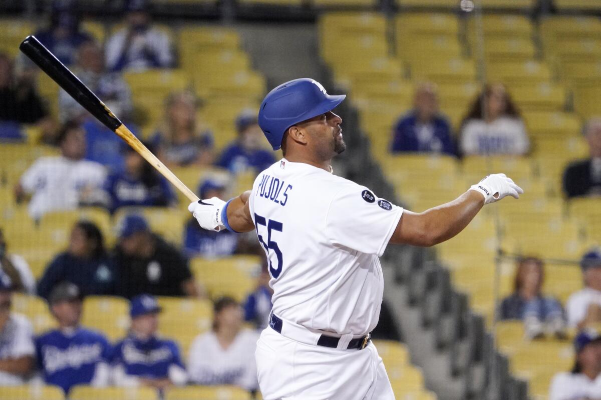 The Dodgers' Albert Pujols hits a solo home run against the Texas Rangers on June 11, 2021.