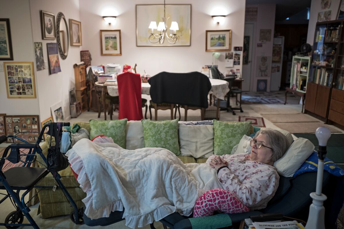 Sharis Woodard, a retired schoolteacher who has lived in Plaza del Rey since 1986, reclines in her living room. In addition to space rent, Woodard also has a mortgage. (David Butow / For The Times)