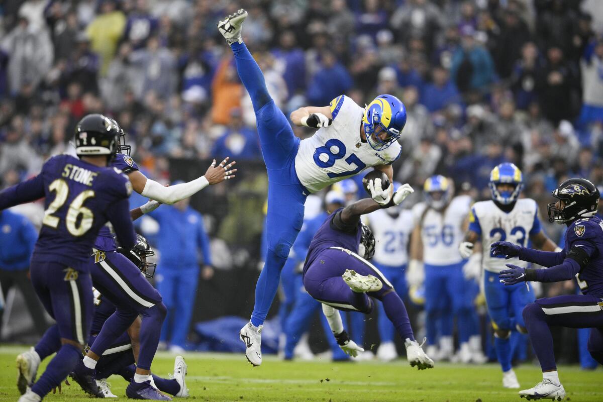 Rams tight end Davis Allen (87) leaps over Ravens linebacker Roquan Smith after making a catch.