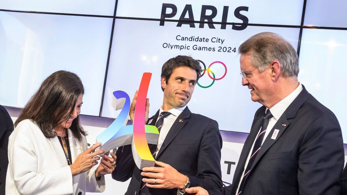 Tony Estanguet, center, co-chairman of the Paris 2024 Organizing Committee, with Paris Mayor Anne Hidalgo and fellow co-chairman Bernard Lapasset during a May 16 news conference.