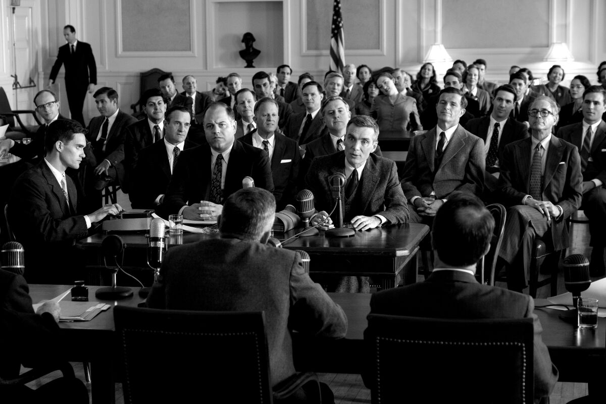 Assembled men listen to the testimony of a speaker.