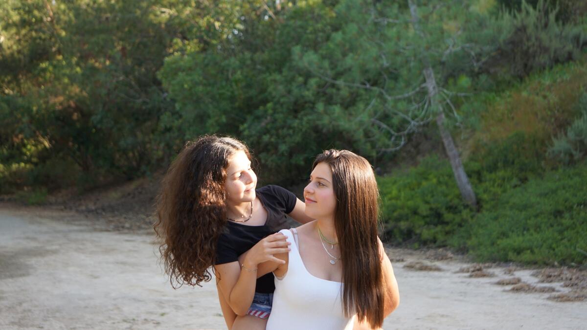 Fania Pupko, 17, and her sister Eliana, 11, make jewelry.