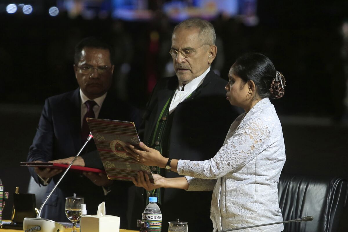 East Timor's new President Jose Ramos-Horta, center, reads his oath during his inauguration ceremony in the capital of Dili, Friday, May 20, 2022. The former independence fighter and Nobel Peace Prize laureate was sworn in as president of Asia's youngest country as it marks its 20th anniversary of independence. (AP Photo/Lorenio Do Rosario Pereira)