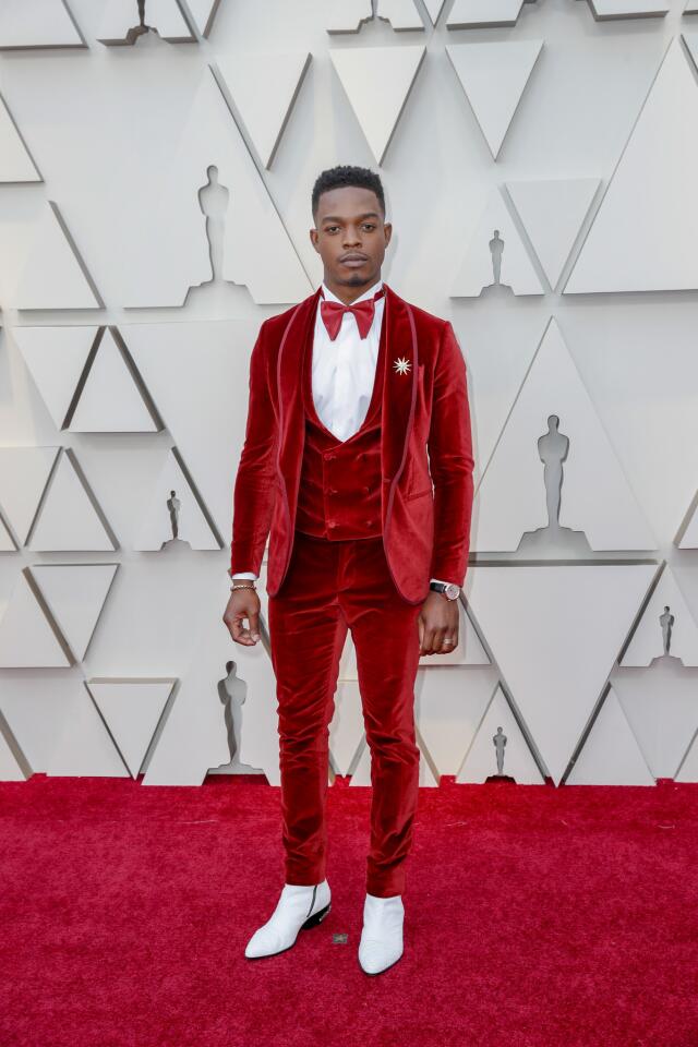 HIT: Stephan James is a red-carpet standout in a custom crimson tuxedo by Etro -- complete with an oversized bowtie.