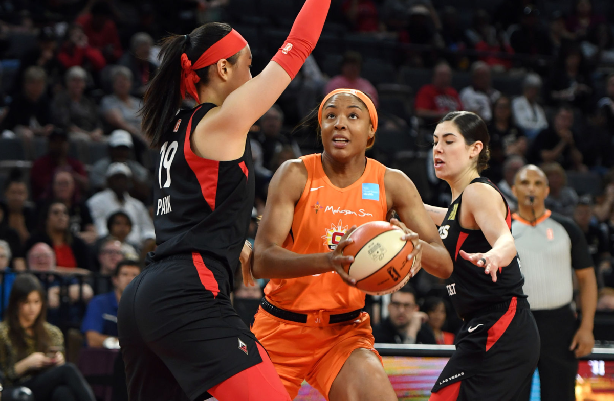 Kristine Anigwe of the Connecticut Sun shoots against JiSu Park and Kelsey Plum.