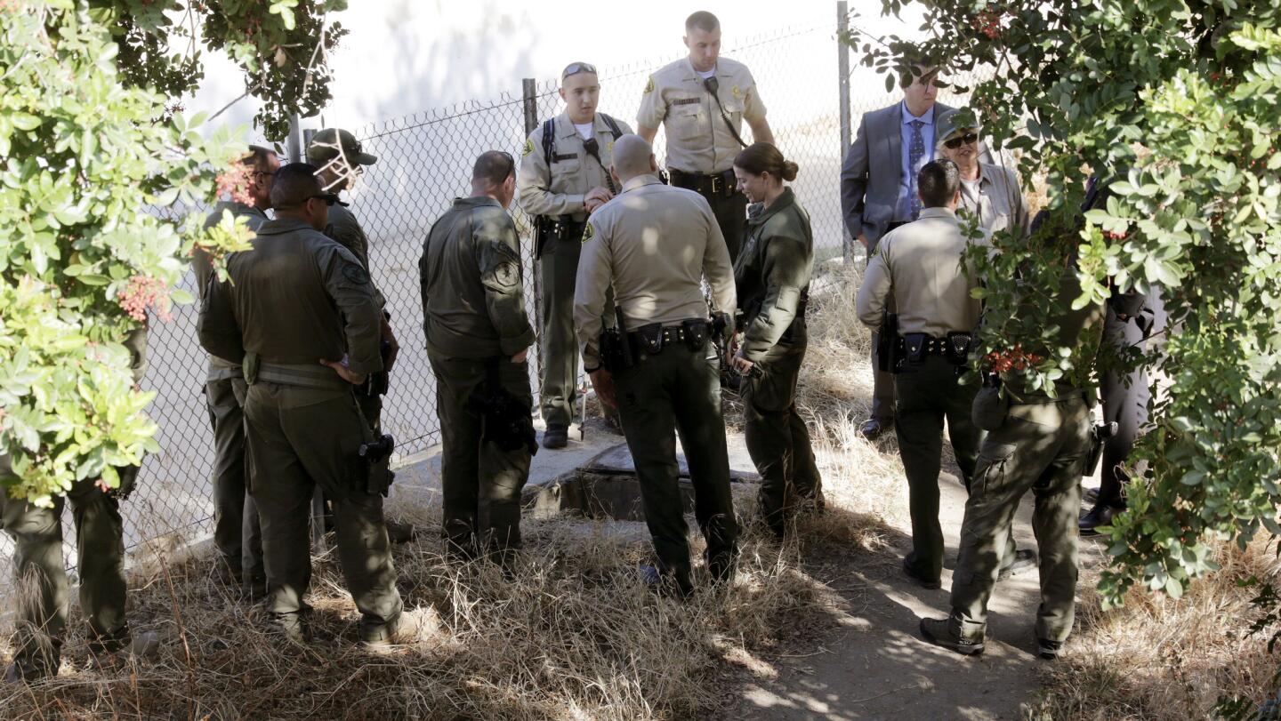 Sheriff's deputies and South Pasadena police officers investigate a drain area in South Pasadena's Arroyo Park looking for clues into the disappearance of five-year-old Aramazd Andressian Jr., who has been missing since April 22.