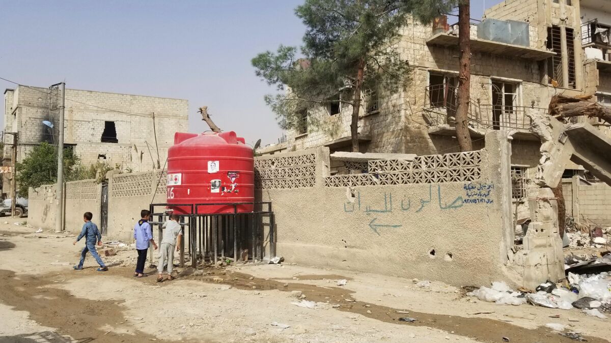 The International Committee of the Red Cross, the Syrian Arab Red Crescent and other aid groups provide plastic tanks filled with drinking water in Duma and other areas of Ghouta for residents dealing with infrastructure shattered by war.
