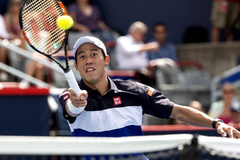 Kei Nishikori returns a shot against Pablo Andujar during their match at the Rogers Cup.