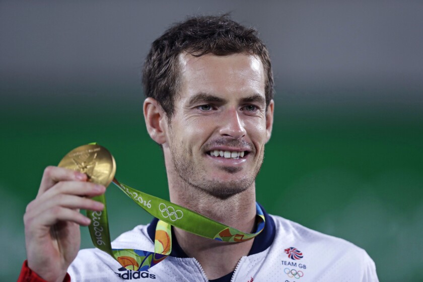 FILE - Andy Murray, of England, smiles as he holds up his gold medal at the 2016 Summer Olympics in Rio de Janeiro, Brazil, in this Sunday, Aug. 14, 2016, file photo. Murray's been through two hip operations and assorted other injuries since he became the first tennis player with multiple Olympic singles golds by winning in 2012 and 2016. His ranking outside the Top 100, but past success — including three Grand Slam trophies — earned him a special spot in the Tokyo field for Britain. “I just hope,” he said, “the body holds up.”(AP Photo/Charles Krupa, File)