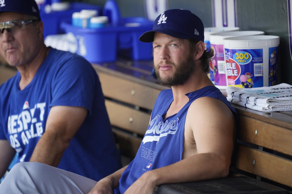 Dodgers pitcher Clayton Kershaw sits in the dugout during batting practice July 17, 2021, in Denver. 