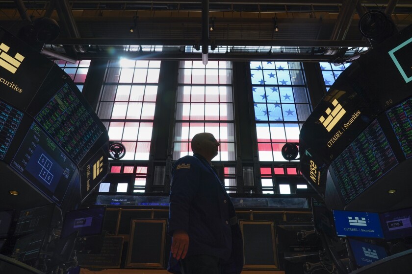 Traders work on the floor at the New York Stock Exchange 