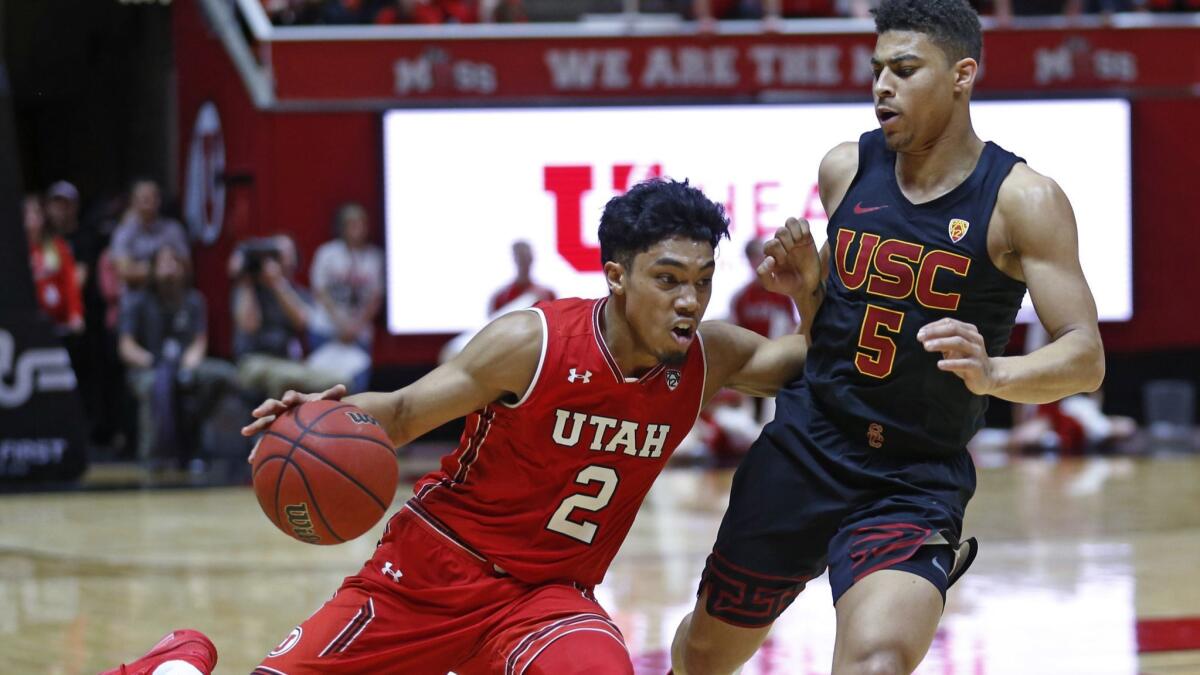 Utah guard Sedrick Barefield (2) drives around USC guard Derryck Thornton (5) during the second half on Thursday in Salt Lake City.