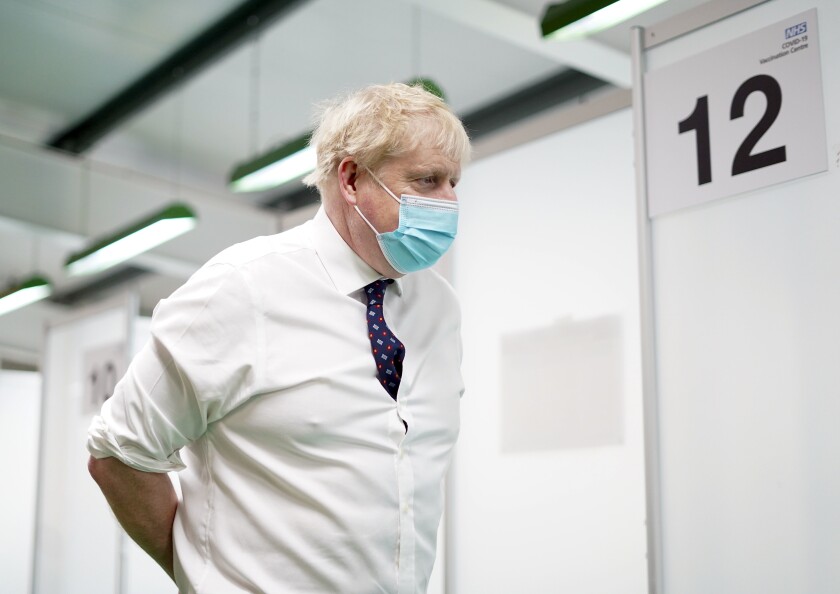 Britain's Prime Minister Boris Johnson visits a vaccination hub in the at Stoke Mandeville Stadium in Aylesbury, England, Monday Jan. 3, 2022, as the booster vaccination programme continues. (Steve Parsons/Pool via AP)