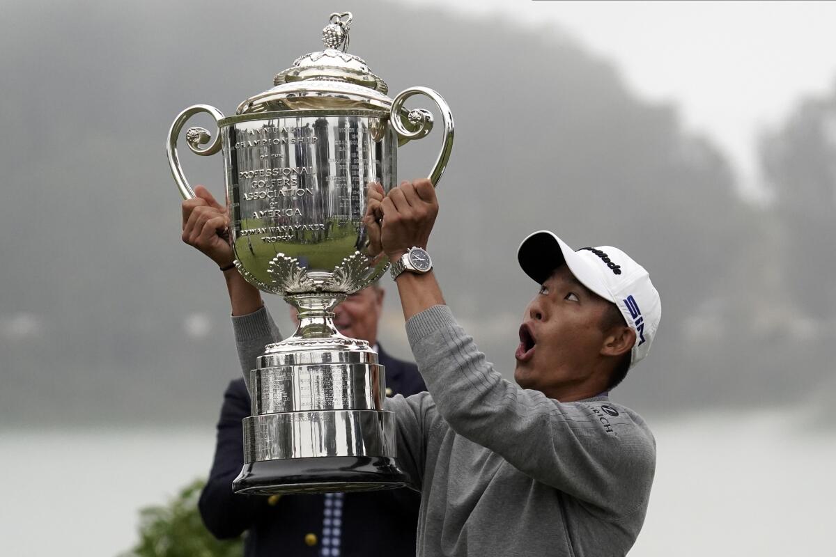 Collin Morikawa reacts as the top of the Wanamaker Trophy falls after winning the PGA Championship.