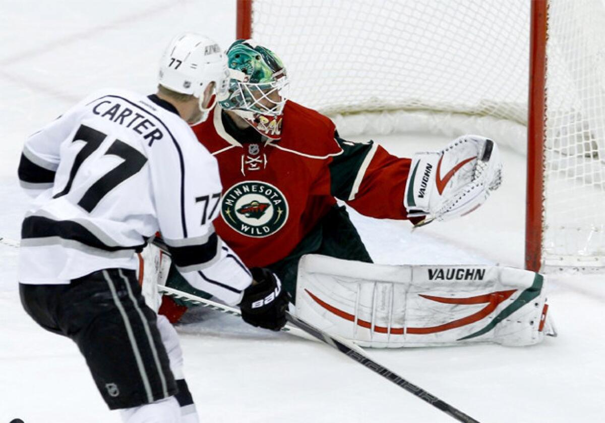 Minnesota Wild goalie Niklas Backstrom (32) stops a shot by Kings center Jeff Carter (77) during the first period.