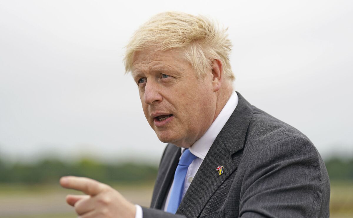 Britain's Prime Minister Boris Johnson gestures after arriving at RAF Brize Norton, in Oxfordshire, England, Saturday, June 18, 2022, following a trip to Ukraine. Johnson met with President Volodymyr Zelenskyy in Kyiv to offer continued aid and military training. (Joe Giddens/Pool Photo via AP)