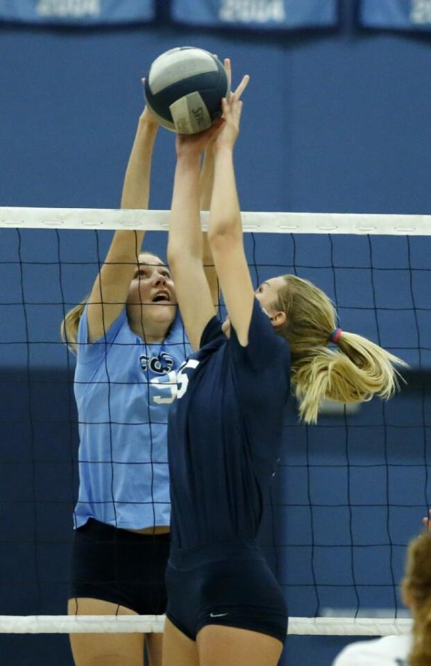 Corona del Mar High's Blair Hodges, left, and Newport Harbor's Delaney DeCinces battle at the net in the Battle of the Bay.