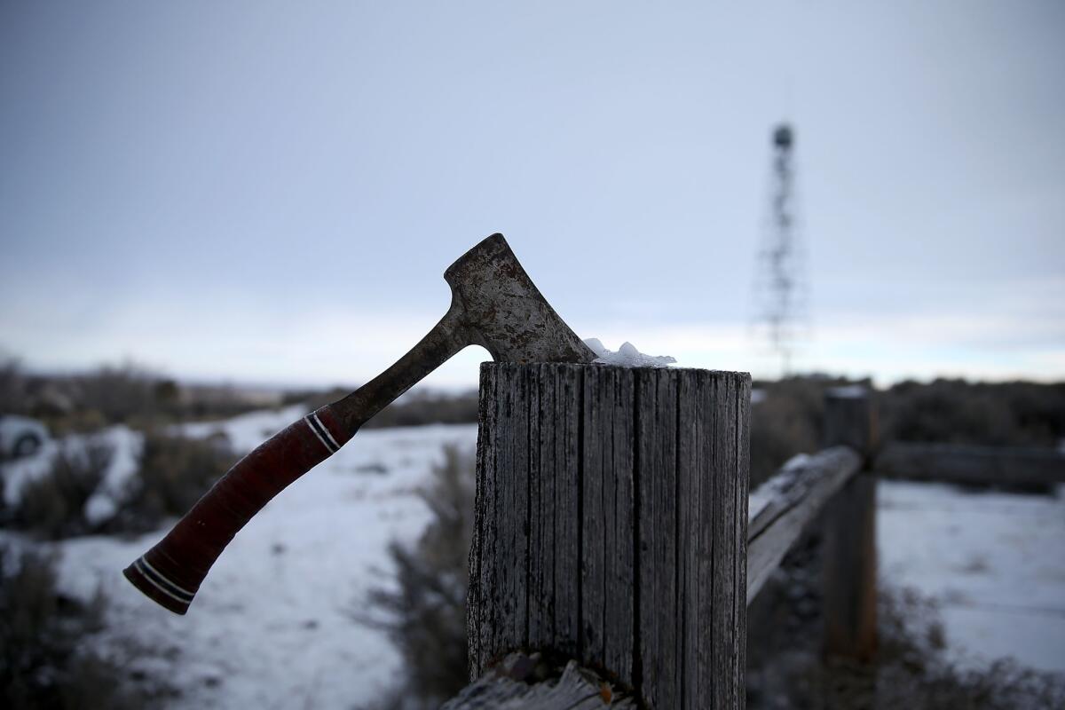 A hatchet is buried in a fence at the Malheur National Wildlife Refuge.