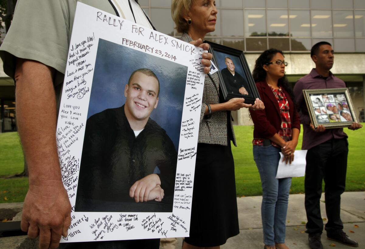 Tim and Tammy Smick, appearing at a news conference in Norwalk in March, hold photos of their son, Alex while Alejandra Gonzales and Miguel Chavez hold pictures of their daughter, Mia Chavez. Both children died as a result of medical negligence.