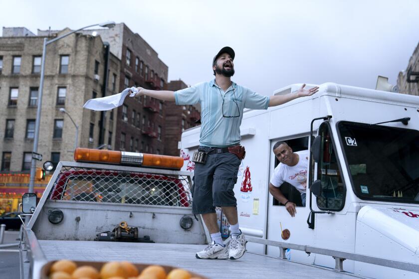 (L-r) LIN-MANUEL MIRANDA as Piragüero and CHRISTOPHER JACKSON as Mr. Softee Truck Driver in Warner Bros. Pictures’ “IN THE HEIGHTS,” a Warner Bros. Pictures release.