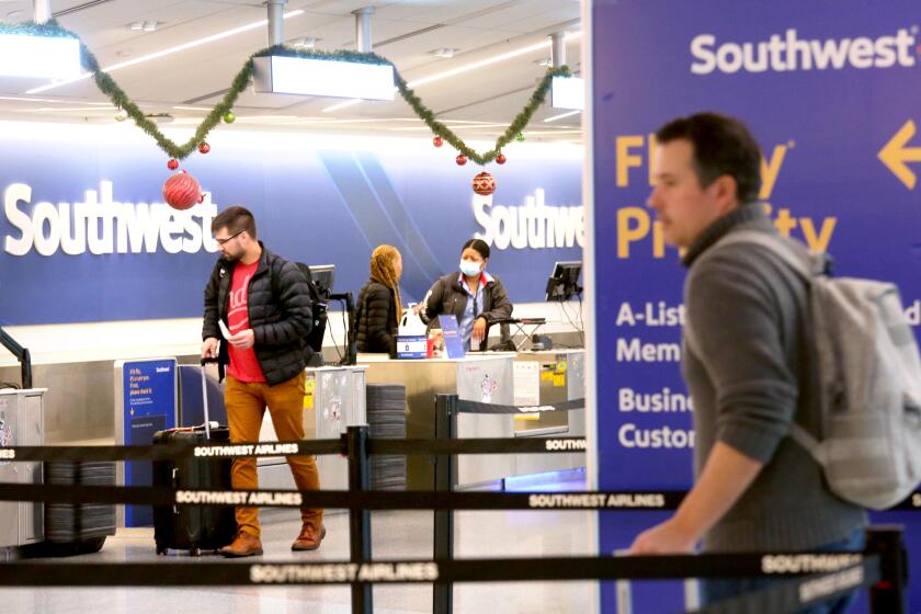 LOS ANGELES, CA - DECEMBER 30, 2022 - - Passengers check in next to an empty queue line as Southwest Airlines resumed regular service at the Los Angeles International Airport on December 9, 2022. (Genaro Molina / Los Angeles Times)
