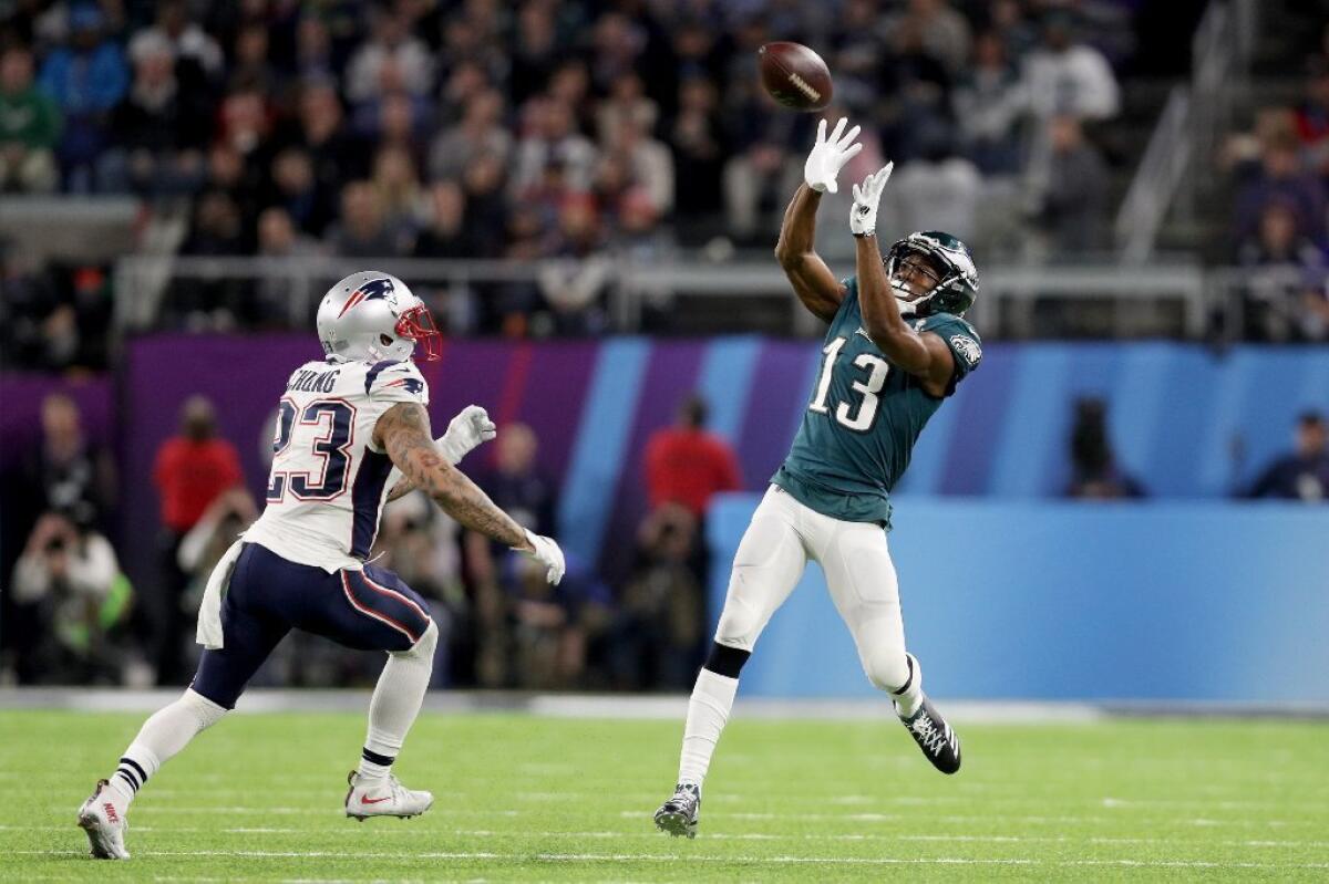 Eagles receiver Nelson Agholor (13) makes a catch over Patriots defensive back Patrick Chung (23) during the fourth quarter in Super Bowl LII.
