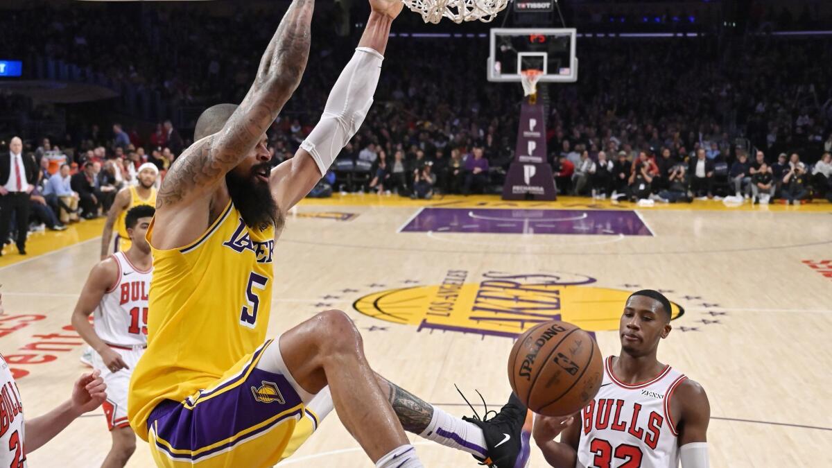 Lakers center Tyson Chandler dunks in front of Chicago Bulls guard Kris Dunn during the second half of the Lakers' 107-100 win Tuesday.