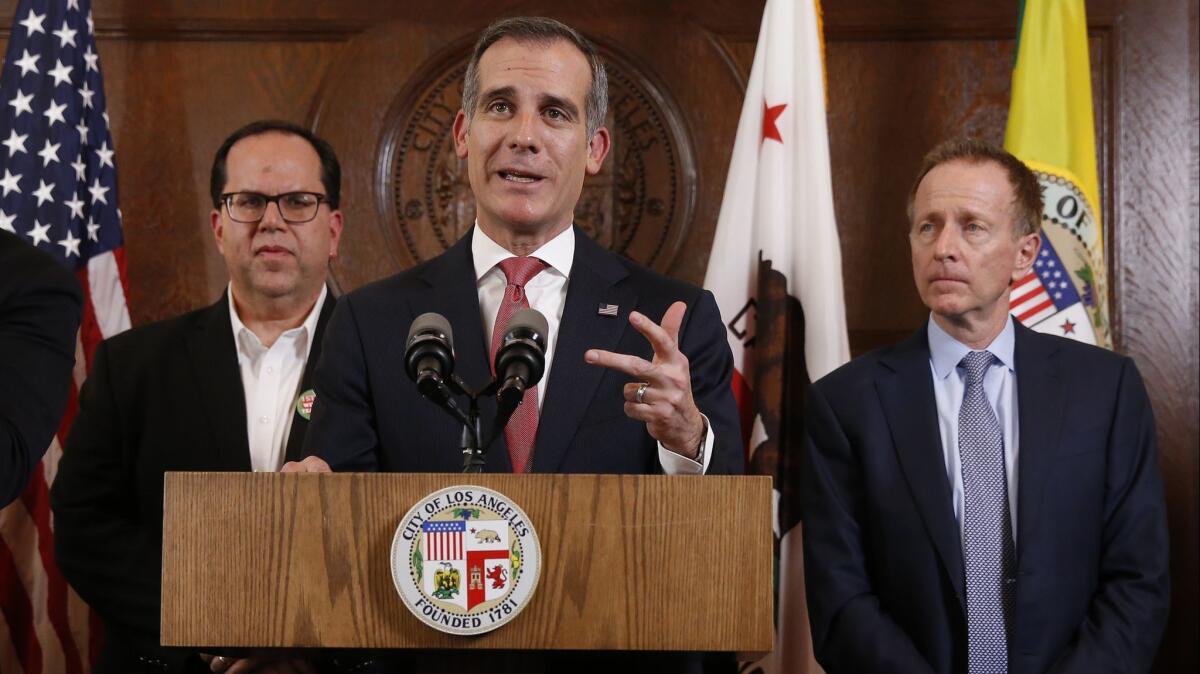 Mayor Eric Garcetti with United Teachers Los Angeles President Alex Caputo-Pearl, left, and L.A. Unified Supt. Austin Beutner, right, at his side announced a resolution to the strike during a press conference at City Hall on Jan. 22.