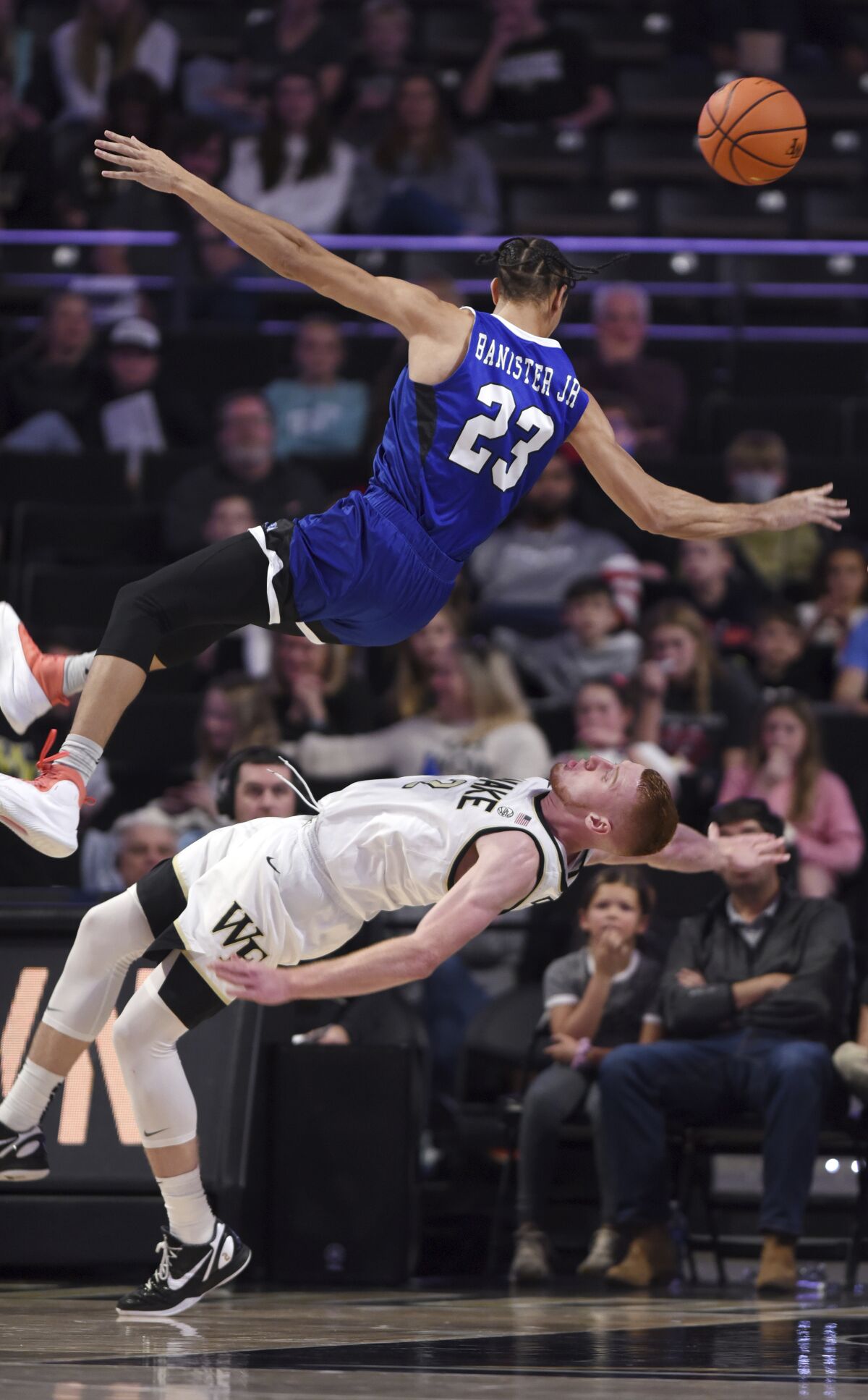 Wake Forest's Cameron Hildreth is called for a block as Hampton's Daniel Banister collides with Hildreth during an NCAA college basketball game, Saturday, Nov. 26, 2022, at Joel Coliseum in Winston-Salem, N.C. (Walt Unks/The Winston-Salem Journal via AP)