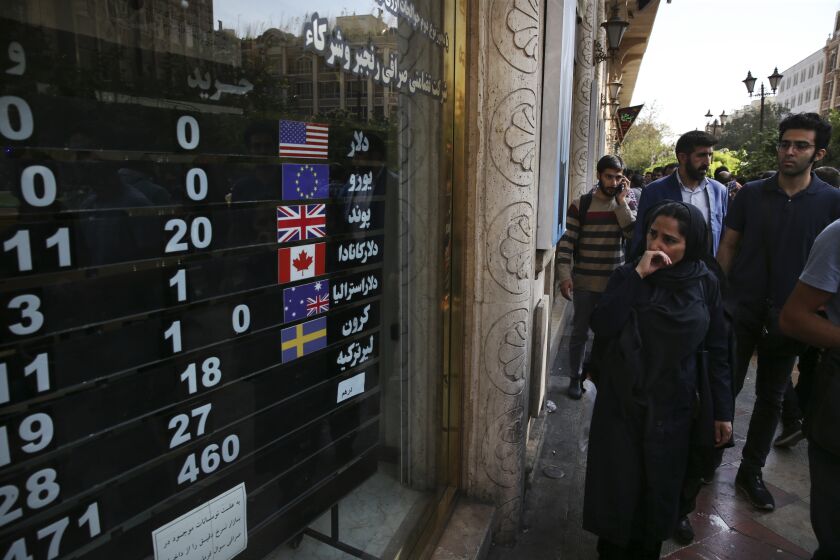 FILE - An exchange shop displays rates for various currencies, in downtown Tehran, Iran, Tuesday, Oct. 2, 2018. Iran and Russia have taken a key step toward linking their banking systems in a move that further boosts their cooperation in the face of Western sanctions, an Iranian official said, Tuesday, Jan. 31, 2023. (AP Photo/Vahid Salemi, File)