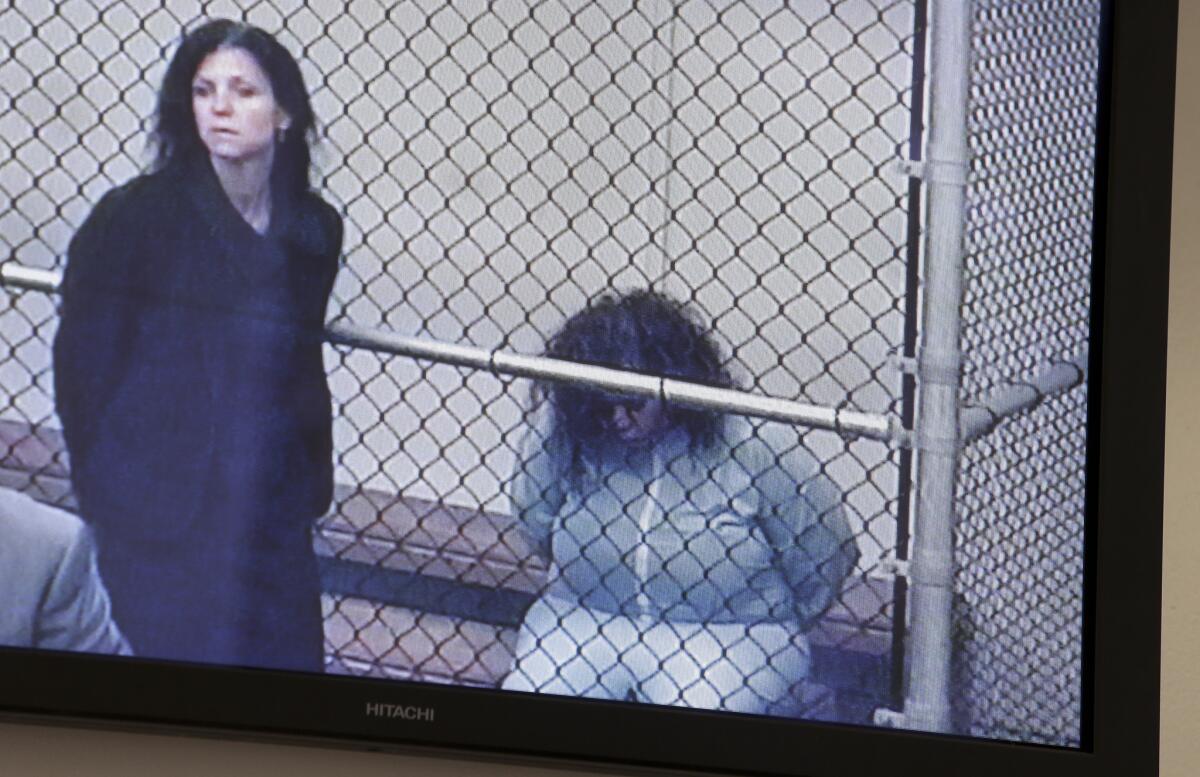 Marilyn Kay Edge, right, appears on a monitor with Orange County deputy public defender Arlene Speiser at a video arraignment in Santa Ana in September 2013.